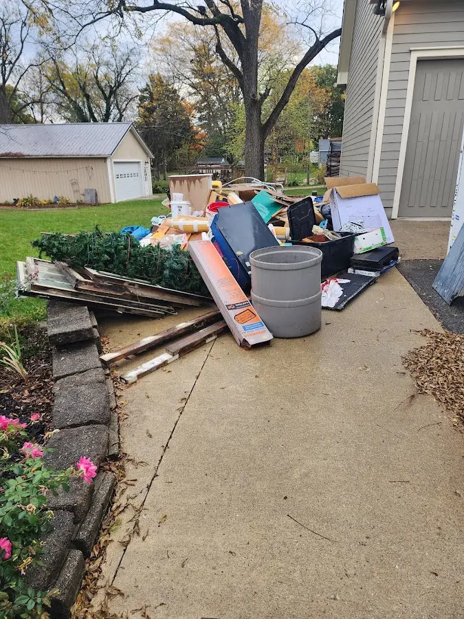 Dumpster being loaded with debris for Commercial Dumpster Rental in Boaz